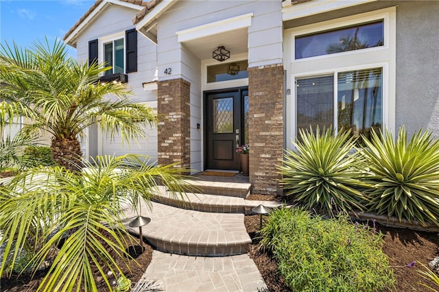 42 Beech Dr, Aliso Viejo, CA 92656 - doorway to property with brick siding and a garage
