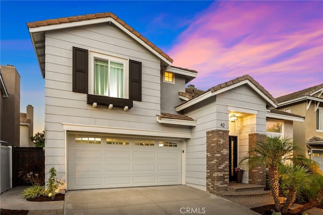 42 Beech Dr, Aliso Viejo, CA 92656 - view of front of property with a tile roof, driveway, a garage, and brick siding