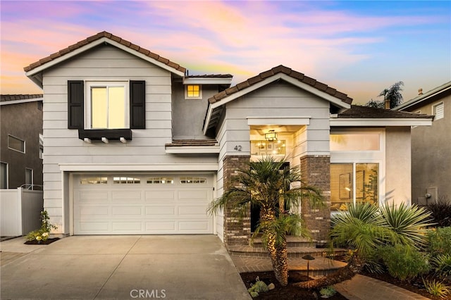 42 Beech Dr, Aliso Viejo, CA 92656 - view of front facade featuring concrete driveway, a tiled roof, and an attached garage