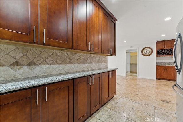500 Jackson Pl Unit 118, Glendale, CA 91206 - kitchen featuring recessed lighting, light stone counters, decorative backsplash, and freestanding refrigerator