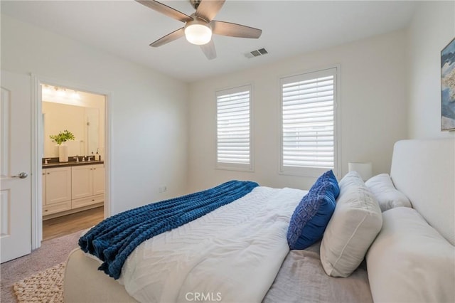18 Jaripol Cir, Rancho Mission Viejo, CA 92694 - bedroom featuring connected bathroom, ceiling fan, and light carpet