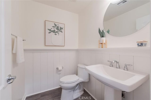 18 Jaripol Cir, Rancho Mission Viejo, CA 92694 - half bathroom featuring a wainscoted wall and wood finished floors