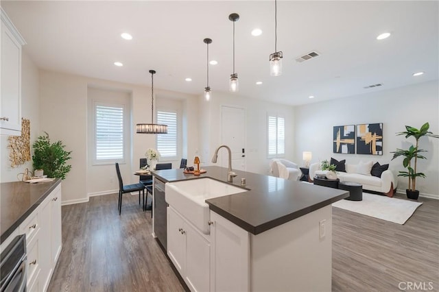 18 Jaripol Cir, Rancho Mission Viejo, CA 92694 - kitchen featuring dark countertops, dark wood-style flooring, recessed lighting, white cabinets, and stainless steel dishwasher