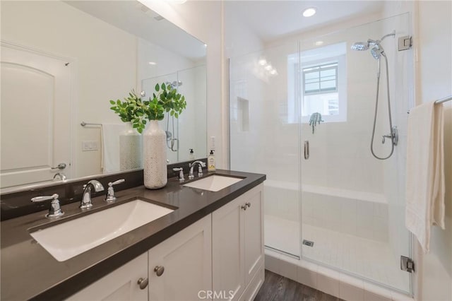 18 Jaripol Cir, Rancho Mission Viejo, CA 92694 - bathroom featuring a stall shower, double vanity, recessed lighting, and wood finished floors