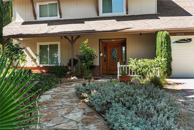20623 Russ Jay St, Saugus, CA 91350 - view of exterior entry featuring a garage, a porch, and roof with shingles