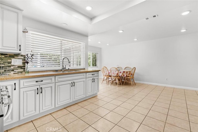 20623 Russ Jay St, Saugus, CA 91350 - kitchen with white cabinets, backsplash, recessed lighting, light tile patterned floors, and stainless steel range