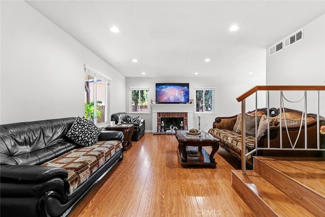 20623 Russ Jay St, Saugus, CA 91350 - living area with light wood finished floors, recessed lighting, and a brick fireplace