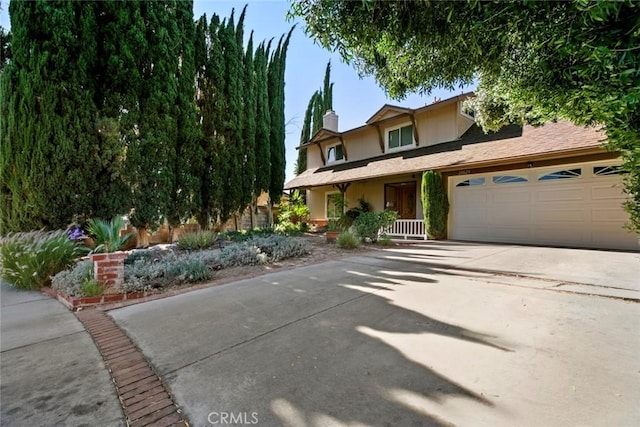 20623 Russ Jay St, Saugus, CA 91350 - view of front of property featuring a chimney, an attached garage, driveway, a porch, and stucco siding
