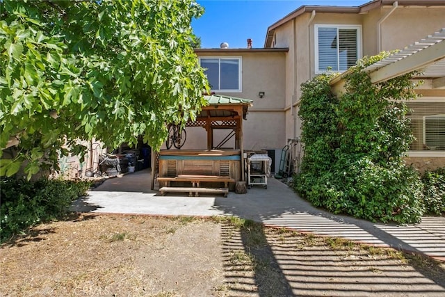 20623 Russ Jay St, Saugus, CA 91350 - back of property with stucco siding, a hot tub, and a patio
