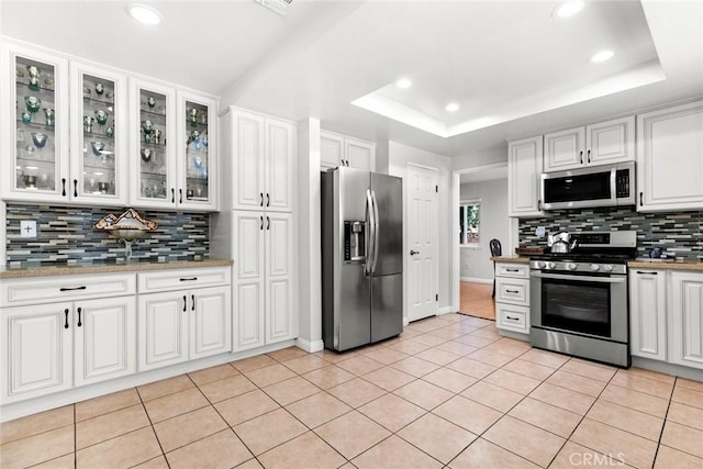 20623 Russ Jay St, Saugus, CA 91350 - kitchen featuring appliances with stainless steel finishes, tasteful backsplash, white cabinets, and recessed lighting
