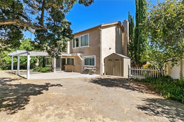 20623 Russ Jay St, Saugus, CA 91350 - rear view of property featuring a storage unit, stucco siding, a patio area, and a chimney