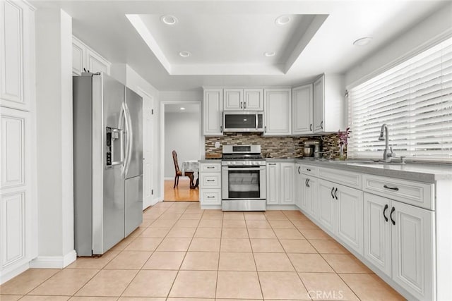 20623 Russ Jay St, Saugus, CA 91350 - kitchen featuring stainless steel appliances, backsplash, light tile patterned flooring, recessed lighting, and white cabinets