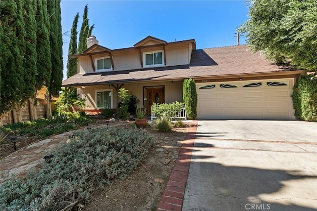 20623 Russ Jay St, Saugus, CA 91350 - traditional-style house featuring a chimney, a garage, and driveway