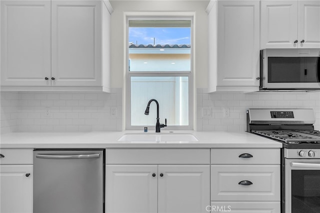 7420 Desert Sky Dr, Yucca Valley, CA 92284 - kitchen with appliances with stainless steel finishes, white cabinetry, tasteful backsplash, and light countertops