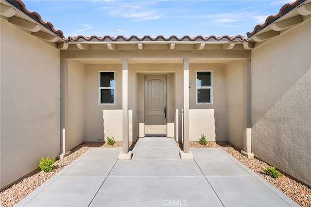 7420 Desert Sky Dr, Yucca Valley, CA 92284 - property entrance with stucco siding and a tile roof