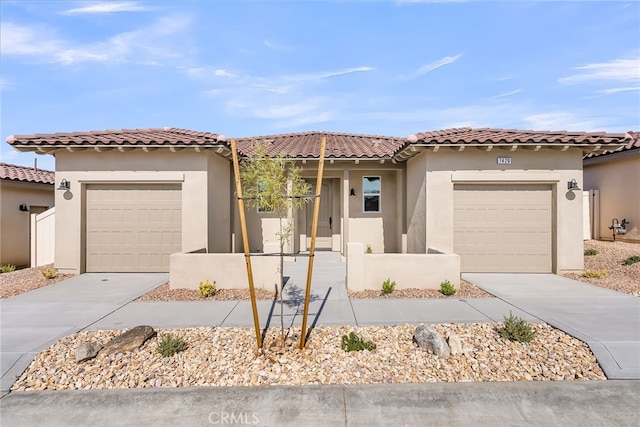 7420 Desert Sky Dr, Yucca Valley, CA 92284 - mediterranean / spanish-style home featuring driveway, an attached garage, stucco siding, and a tiled roof