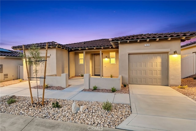 7420 Desert Sky Dr, Yucca Valley, CA 92284 - mediterranean / spanish house with driveway, a garage, stucco siding, and a tiled roof