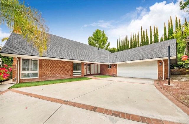 22905 De Kalb Dr, Calabasas, CA 91302 - view of front facade featuring an attached garage, concrete driveway, and brick siding