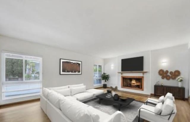 22905 De Kalb Dr, Calabasas, CA 91302 - living room with light wood finished floors and a lit fireplace
