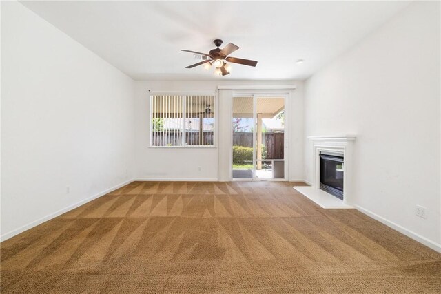 6631 Aggies Ct, Winton, CA 95388 - unfurnished living room with light colored carpet, ceiling fan, and a glass covered fireplace
