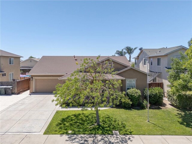 6631 Aggies Ct, Winton, CA 95388 - view of front facade with stucco siding, driveway, an attached garage, and a residential view
