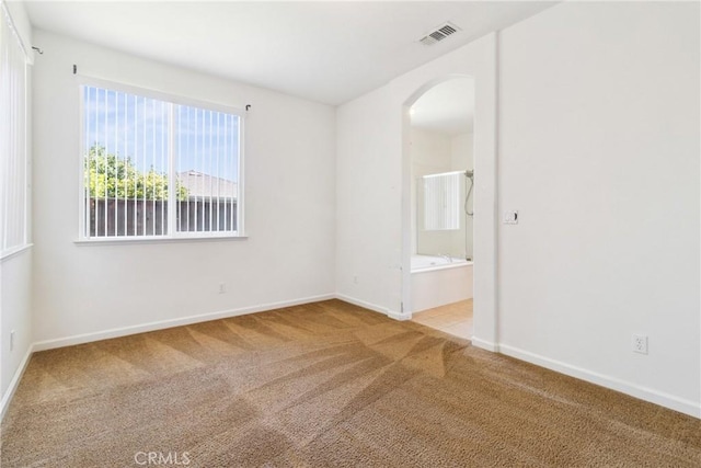 6631 Aggies Ct, Winton, CA 95388 - carpeted spare room featuring arched walkways and baseboards