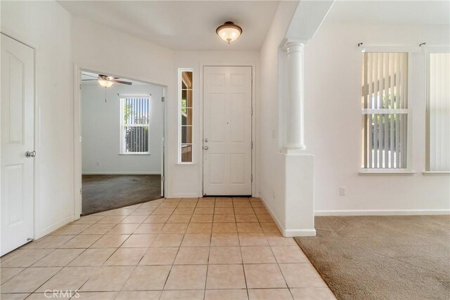 6631 Aggies Ct, Winton, CA 95388 - entrance foyer with light colored carpet, decorative columns, a ceiling fan, and light tile patterned floors