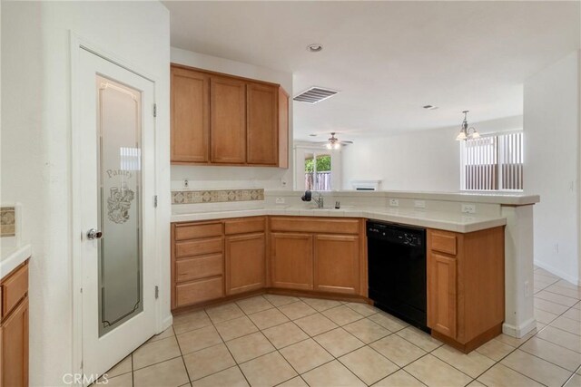 6631 Aggies Ct, Winton, CA 95388 - kitchen featuring black dishwasher, a peninsula, light tile patterned flooring, and brown cabinetry