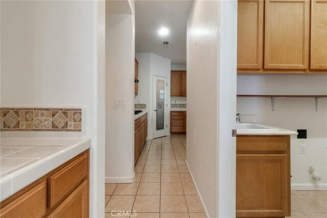 6631 Aggies Ct, Winton, CA 95388 - kitchen featuring light tile patterned flooring and tile countertops