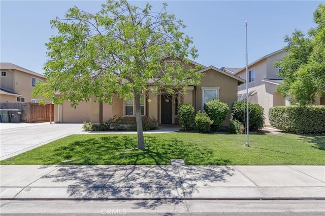 6631 Aggies Ct, Winton, CA 95388 - view of front of home with an attached garage, stucco siding, and driveway