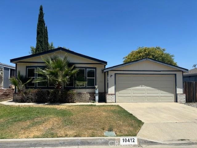 10412 Comstock Rd, Corona, CA 92883 - view of front of home featuring concrete driveway, an attached garage, and a front lawn