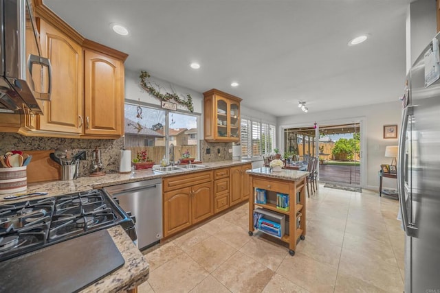 151 Camino Vista Real, Chula Vista, CA 91910 - kitchen featuring appliances with stainless steel finishes, decorative backsplash, light stone counters, recessed lighting, and light tile patterned floors