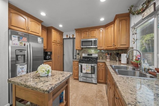 151 Camino Vista Real, Chula Vista, CA 91910 - kitchen with appliances with stainless steel finishes, brown cabinets, tasteful backsplash, recessed lighting, and light stone countertops