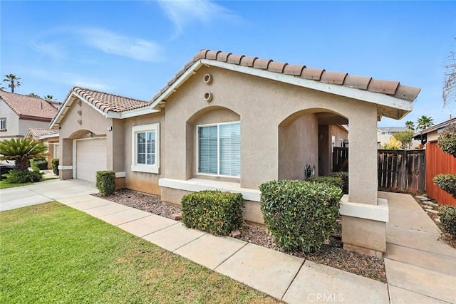 25780 Jumano Dr, Moreno Valley, CA 92551 - mediterranean / spanish-style house with stucco siding, an attached garage, driveway, and a tile roof
