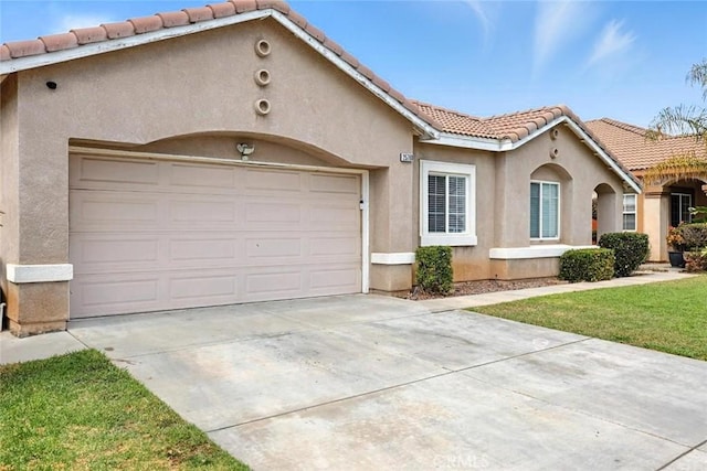 25780 Jumano Dr, Moreno Valley, CA 92551 - mediterranean / spanish-style home featuring a tiled roof, stucco siding, concrete driveway, and a garage