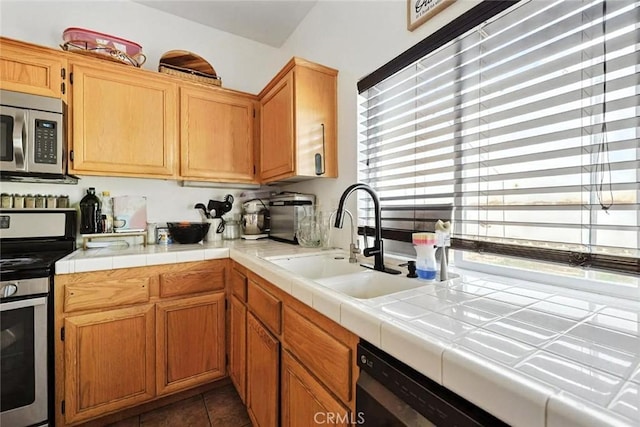 25780 Jumano Dr, Moreno Valley, CA 92551 - kitchen with appliances with stainless steel finishes, light countertops, and dark tile patterned floors