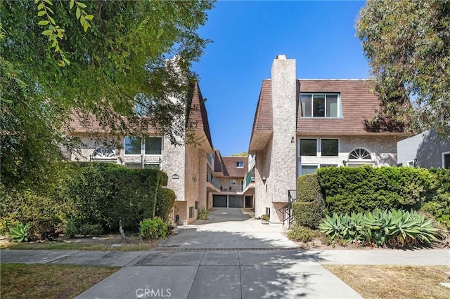 312 N Francisca Ave Unit 1, Redondo Beach, CA 90277 - view of front of property with stucco siding, a chimney, and driveway