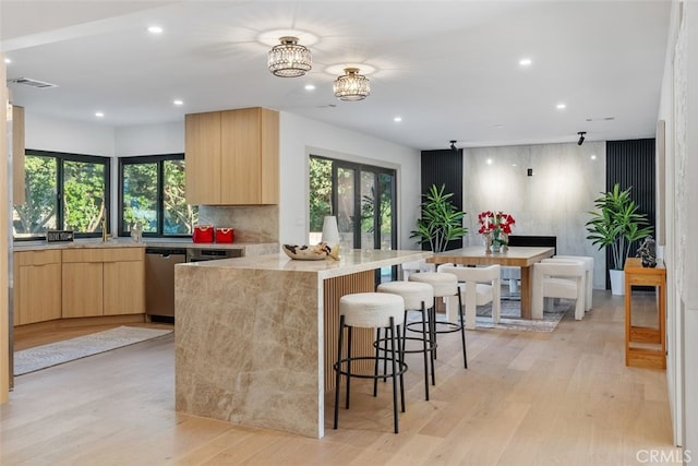 6032 Sun Knoll Cir, Yorba Linda, CA 92886 - kitchen featuring light brown cabinetry, a breakfast bar, light wood-style floors, modern cabinets, and recessed lighting