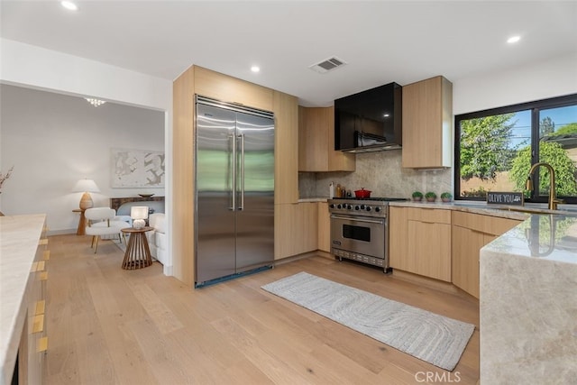 6032 Sun Knoll Cir, Yorba Linda, CA 92886 - kitchen with high end appliances, light brown cabinets, extractor fan, light wood-type flooring, and modern cabinets
