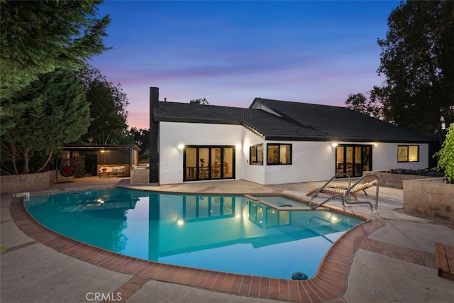 6032 Sun Knoll Cir, Yorba Linda, CA 92886 - rear view of property featuring french doors, a patio, a tiled roof, stucco siding, and a pool with connected hot tub