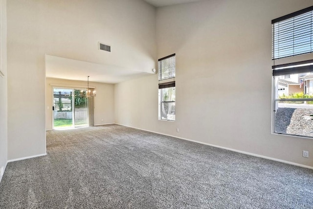 2053 Sequoia St, San Marcos, CA 92078 - spare room with a chandelier, a high ceiling, carpet flooring, and healthy amount of natural light