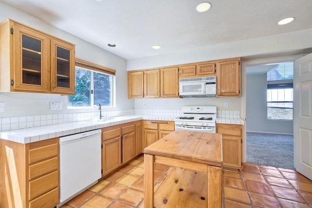 2053 Sequoia St, San Marcos, CA 92078 - kitchen featuring white appliances, healthy amount of natural light, glass insert cabinets, recessed lighting, and light colored carpet
