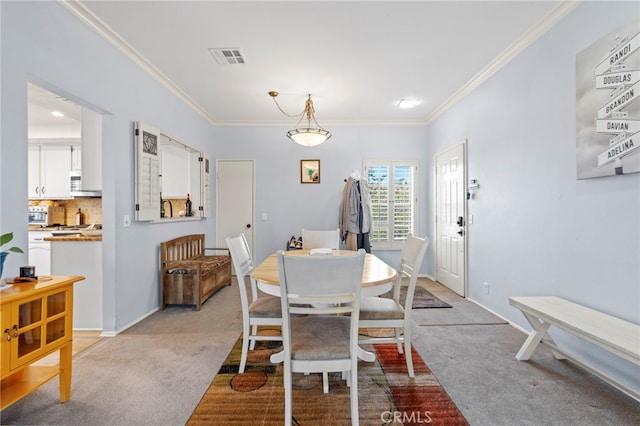 42821 15th St W Unit 4, Lancaster, CA 93534 - dining area featuring carpet flooring and crown molding