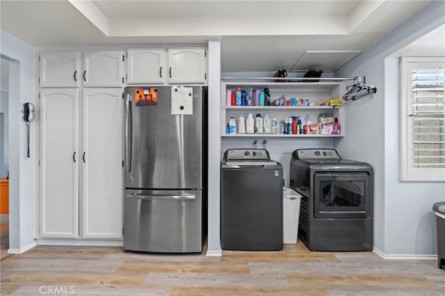 42821 15th St W Unit 4, Lancaster, CA 93534 - laundry room featuring washing machine and dryer and light wood-style flooring