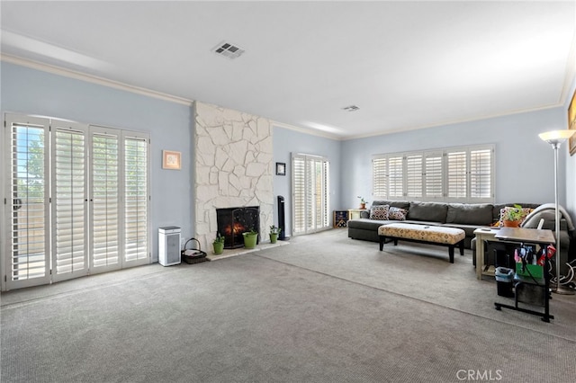 42821 15th St W Unit 4, Lancaster, CA 93534 - carpeted living area featuring crown molding and a stone fireplace