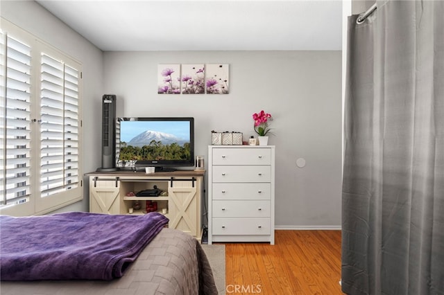 42821 15th St W Unit 4, Lancaster, CA 93534 - bedroom featuring multiple windows and light wood-style floors