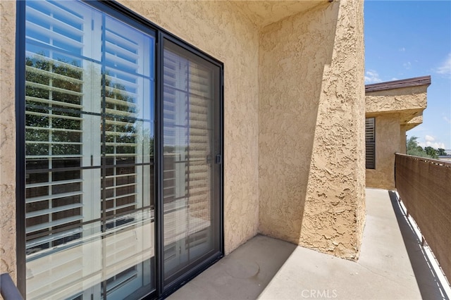 42821 15th St W Unit 4, Lancaster, CA 93534 - doorway to property with stucco siding and a balcony