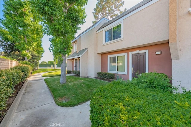 3 Albany Unit 61, Irvine, CA 92604 - view of side of property with stucco siding and a yard