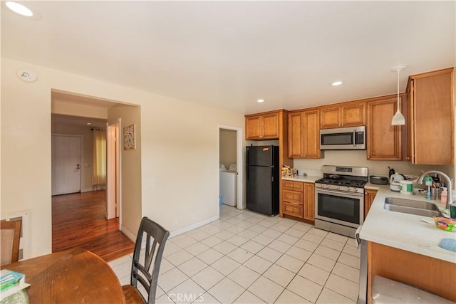 3 Albany Unit 61, Irvine, CA 92604 - kitchen with stainless steel appliances, brown cabinetry, light countertops, light tile patterned floors, and recessed lighting
