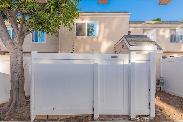 3 Albany Unit 61, Irvine, CA 92604 - view of front facade with a gate and stucco siding